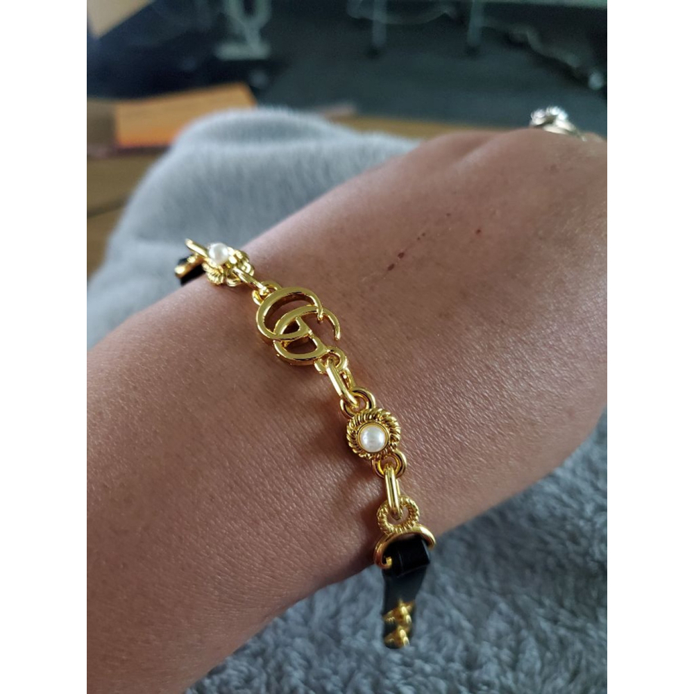 Black & Gold chain bracelet with faux leather and snap. Fit up to size 7.34